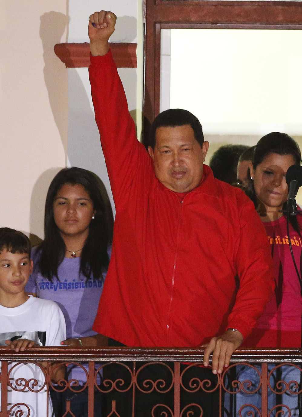 Venezuelan President Hugo Chavez celebrates from a balcony at Miraflores Palace in Caracas