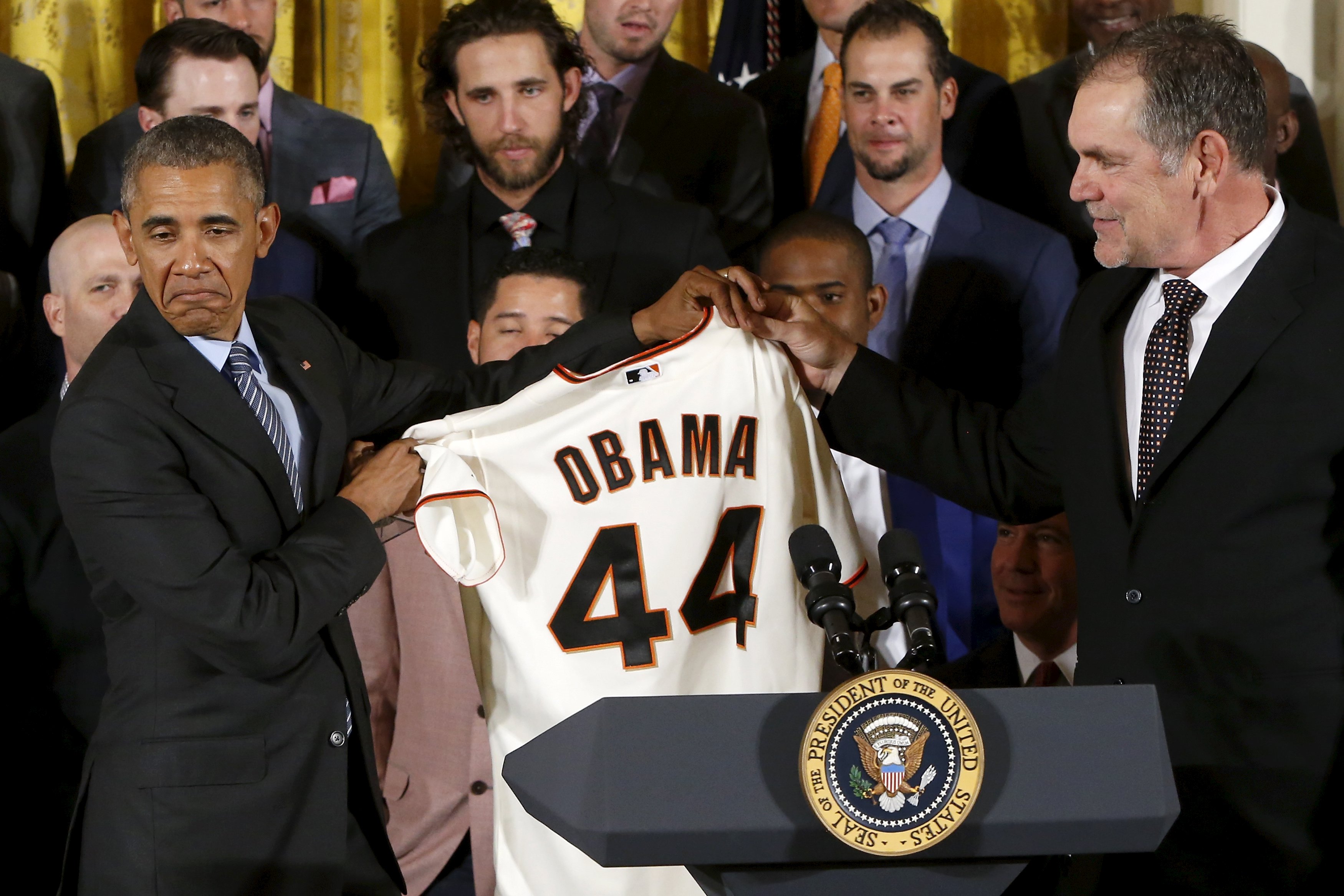 Obama reacts as he receives a team jersey from Bochy as he plays host to a reception for the San Francisco Giants in the East Room of the White House in Washington