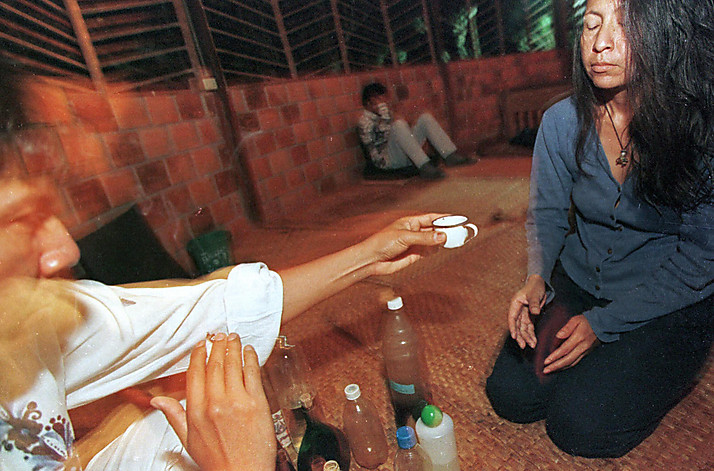 (FILE) Picture taken in February 1999 of a healer (L) starting an Ayahuasca ceremony by offering -what they call- the medicinal plant to a person taking part of the ritual in Tarapoto, northeastern jungle of Peru. The Ayahuasca modifies the state of conciousness and is believed to recover those who take it. AFP PHOTO / JAIME RAZURI (Photo credit should read JAIME RAZURI/AFP/Getty Images)